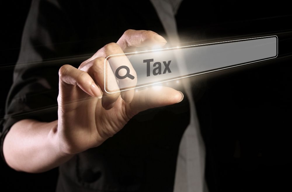 Mans Hand And Tax Sign