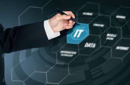 Businessman Pointing To Word "IT" With Pen