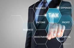 Businessman Pointing To Sign Saying "Tax"