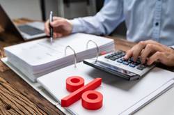 Man Working On Tax At Desk