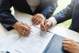 Business partners reviewing a UAE partnership agreement for Dubai company formation.