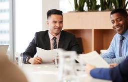 Business advisers reviewing documents during a corporate bank account application in Dubai.