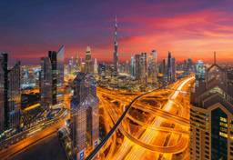 Dubai skyline at sunset with Burj Khalifa and Sheikh Zayed Road.