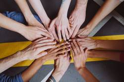 Diverse Range Of Hands In Team Handshake