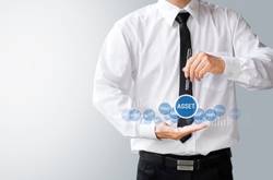 Businessman With Signs Saying Assets