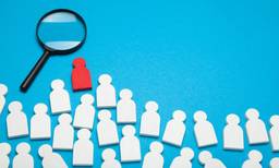 Magnifying Glass With Stick Figures Showing Talent Acquisition