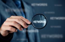 Keywords With Businessman And Magnifying Glass