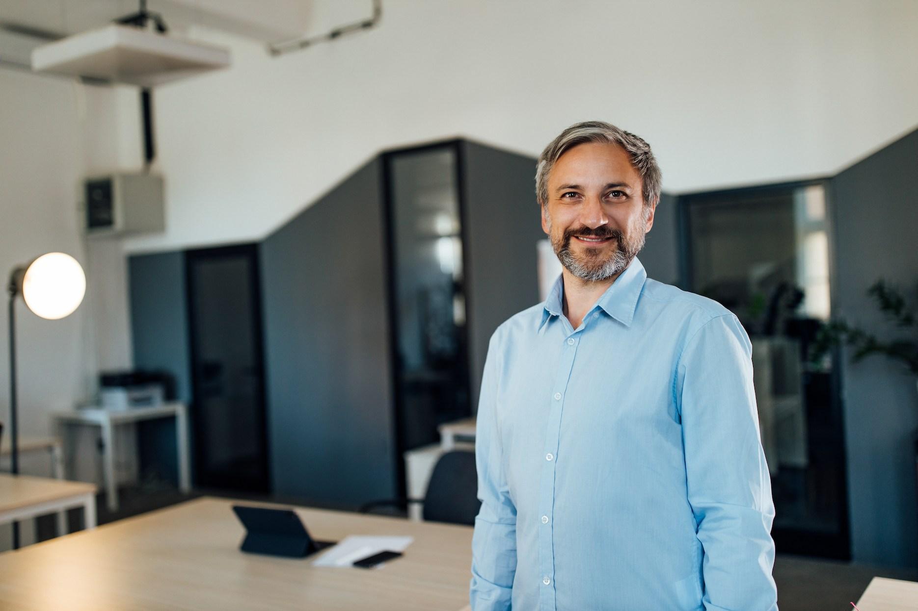 IT company founder in a modern office preparing to start an IT business in Dubai.