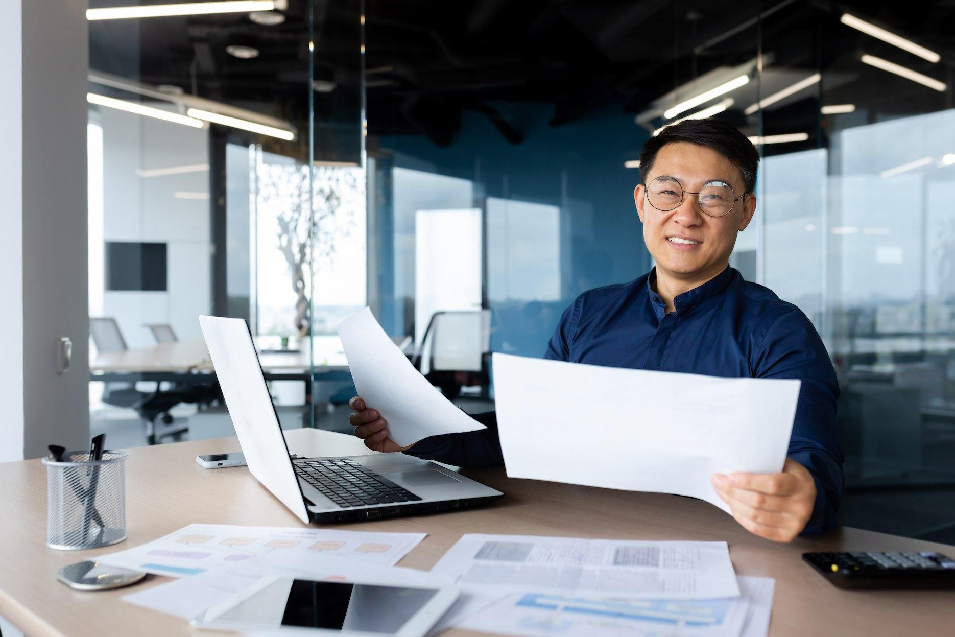 Business owner reviewing company documents before opening a business bank account in Dubai.
